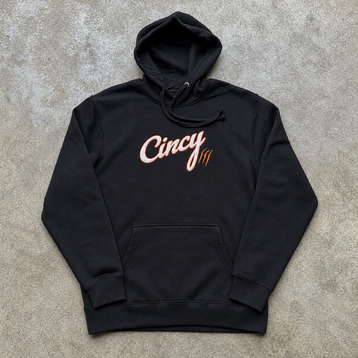 Front view of black Cincy hoodie with white twill lettering outlined in orange