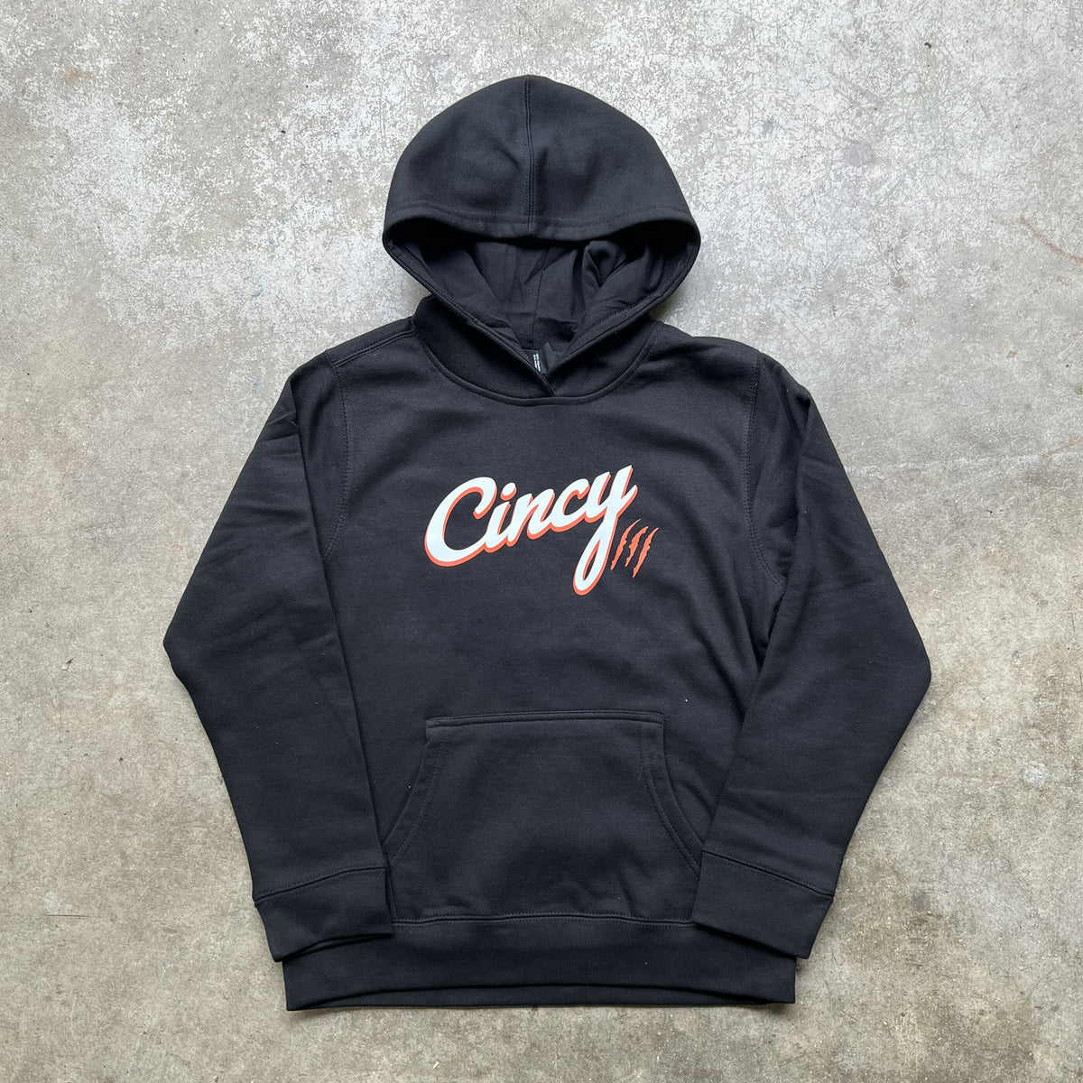 Front view of black youth Cincy hoodie with white and orange printed logo and orange claw-mark accents