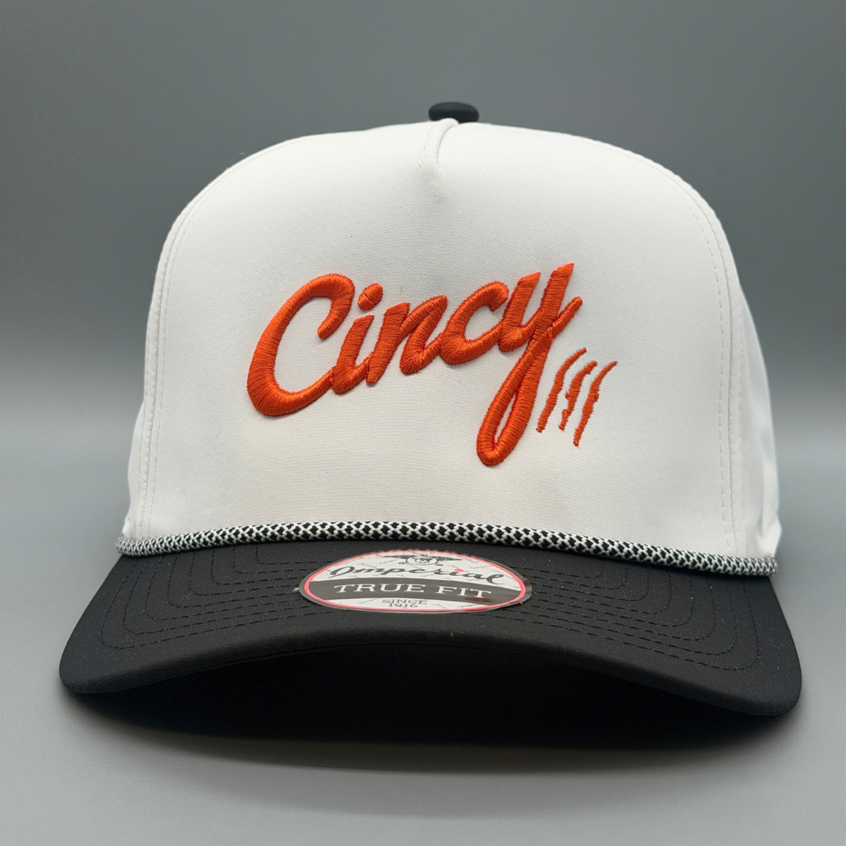 Front view of the white and black OG 5 Panel two-tone hat with puffed orange Cincy script logo