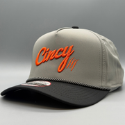 Angled view of the grey and black OG 5 Panel hat with orange Cincy logo and contrast rope trim on the brim