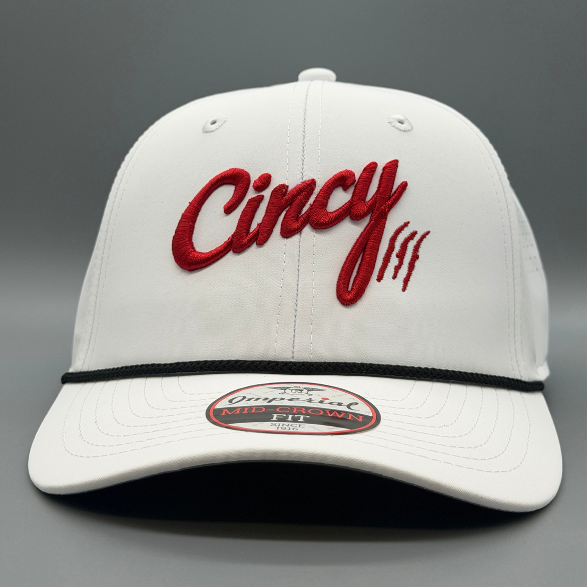 Front view of the white Cincy Airflow hat with puffed red Cincy script logo