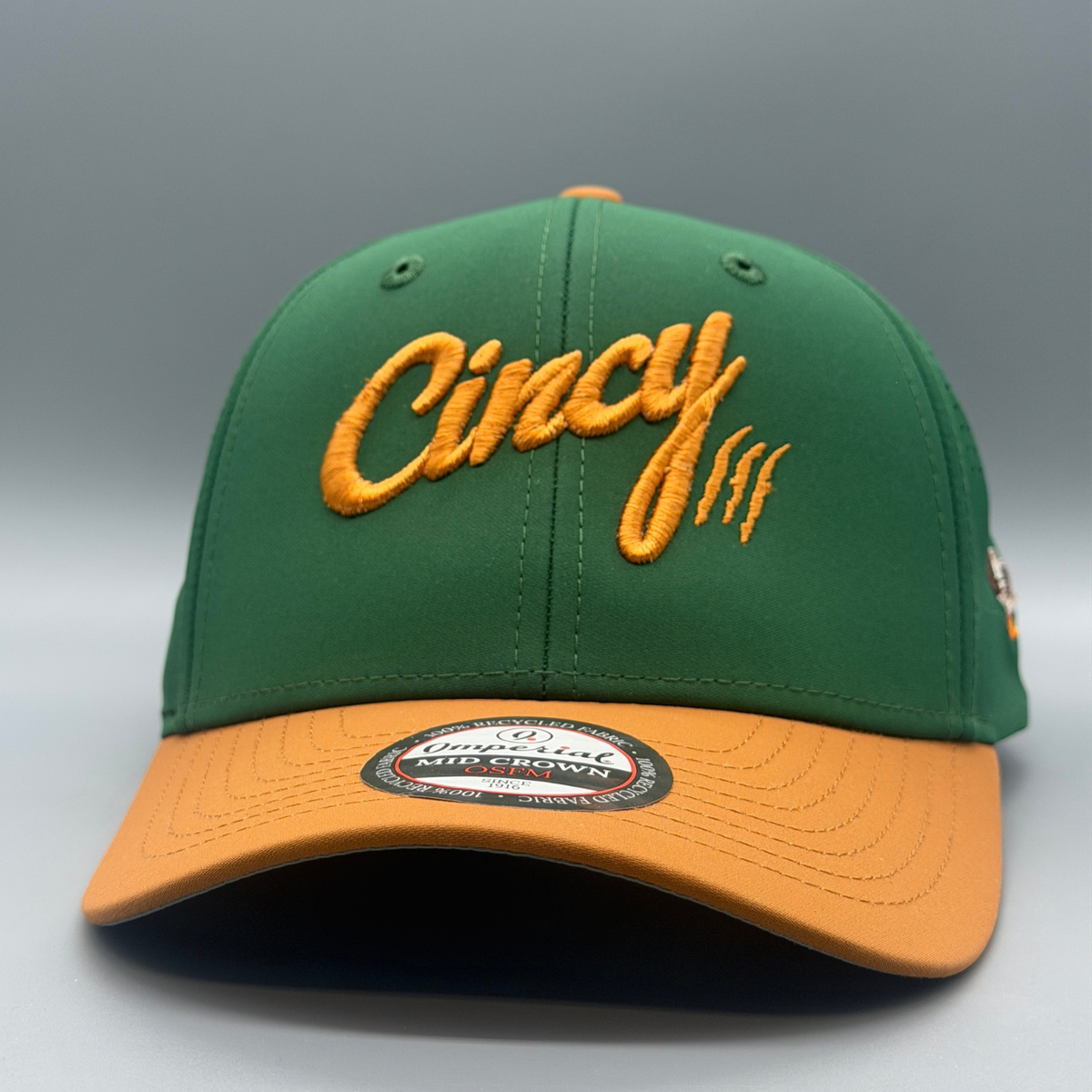 Front view of The Mallard cap, a green mid-crown hat with a gold brim and embroidered gold Cincy script logo