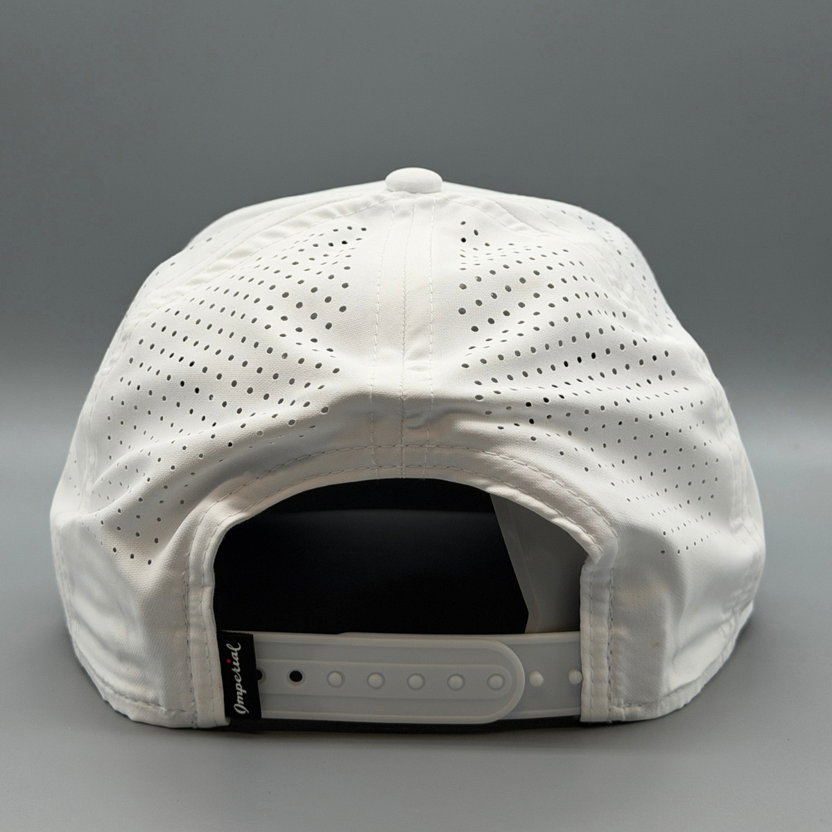Back view of the white Cincy Airflow hat showing perforated panels and adjustable strap closure