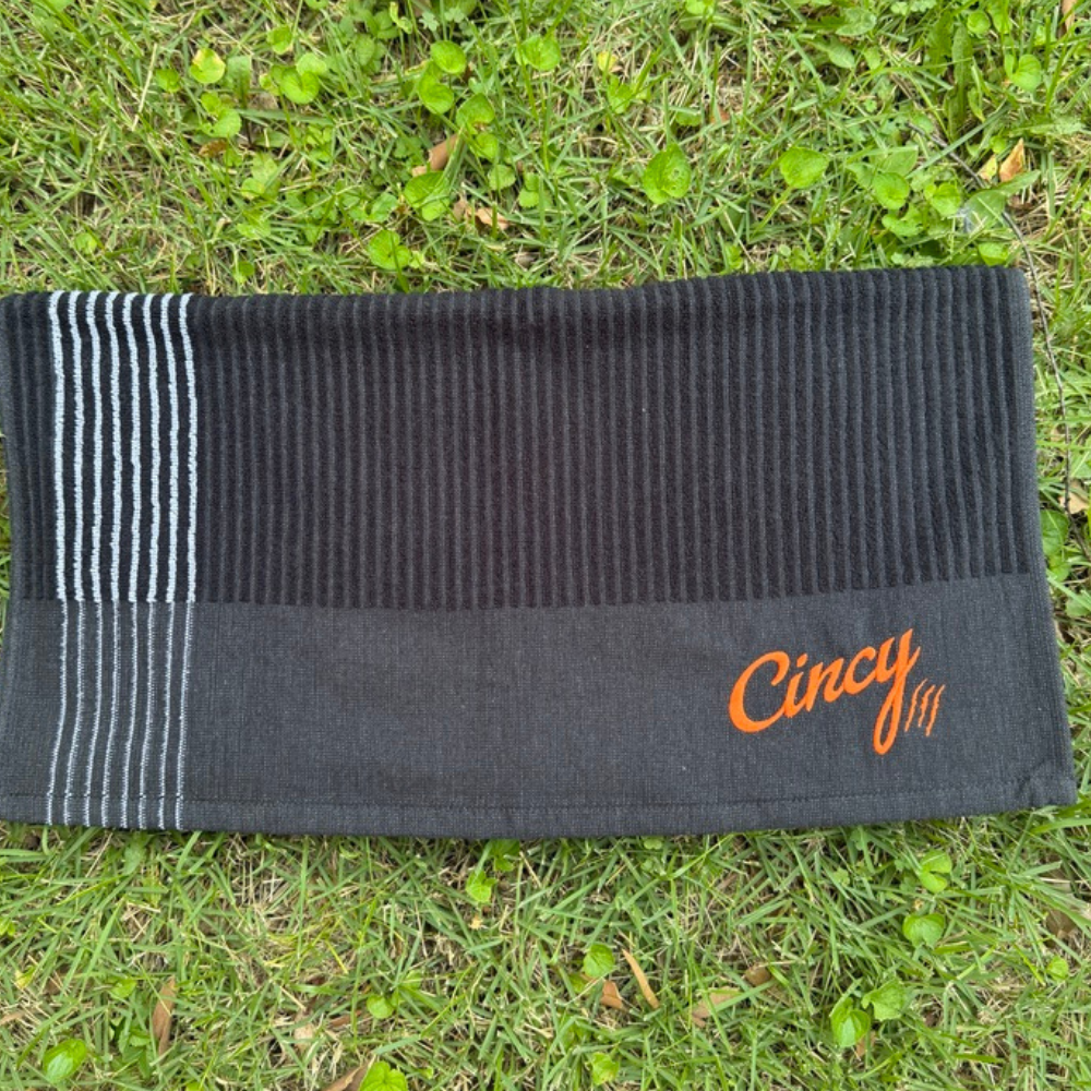 The Cincy Golf Towel - Winston Collection - Black, flat lay on grass