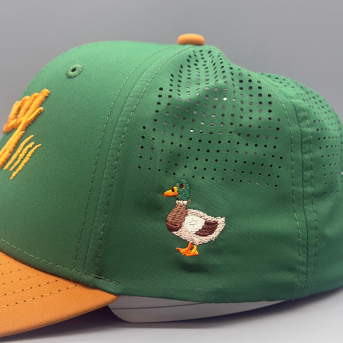 Close-up of the embroidered mallard duck detail on the side panel of The Mallard cap