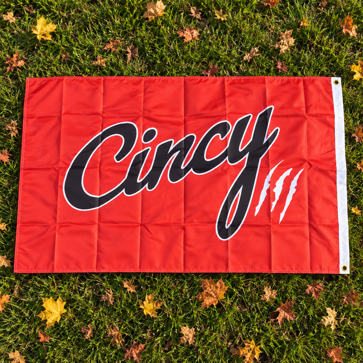 Orange Cincy house flag with black script and white claw marks
