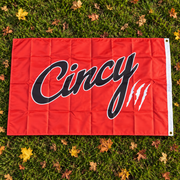Orange Cincy house flag with black script and white claw marks